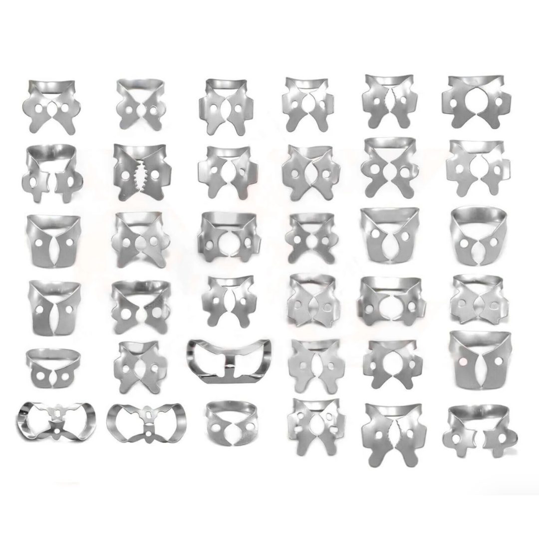 Assorted stainless steel rubber dam clamps in various shapes and sizes arranged in rows